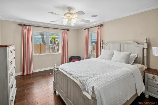 a bedroom with a large bed and a chandelier