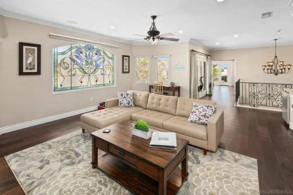 a living room with furniture and a wooden floor