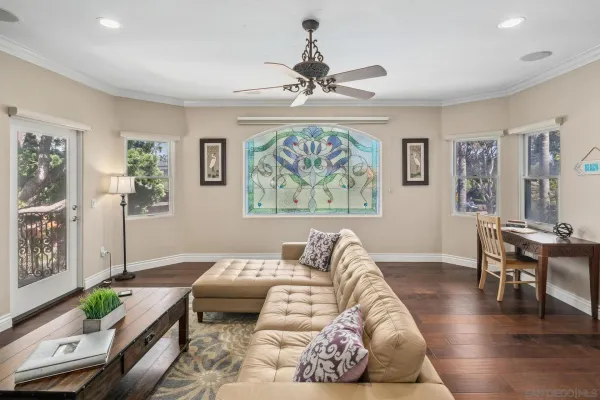 a living room with furniture toys and wooden floor