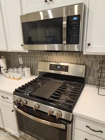 a close view of a stove a microwave and cabinets