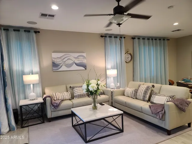 a living room with furniture and a chandelier