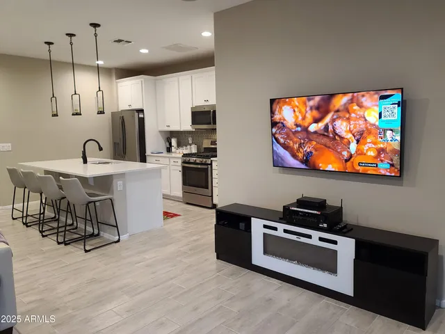 a kitchen with stainless steel appliances kitchen island granite countertop a stove and a refrigerator
