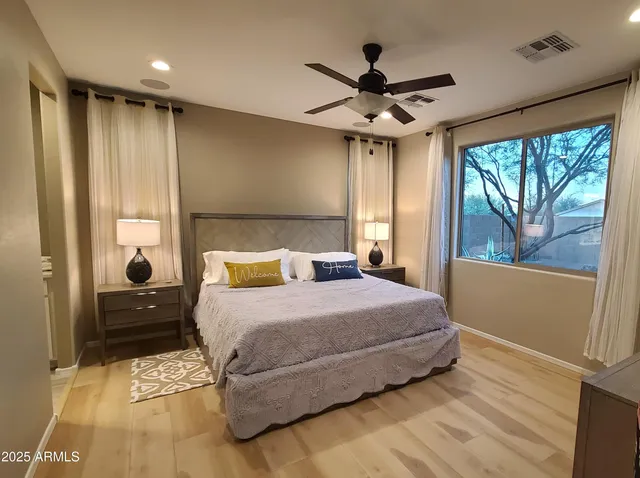 a bedroom with a large bed and a chandelier