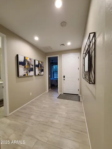a view of a hallway with wooden floor