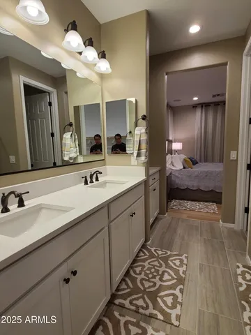 a spacious bathroom with a double vanity sink and a mirror