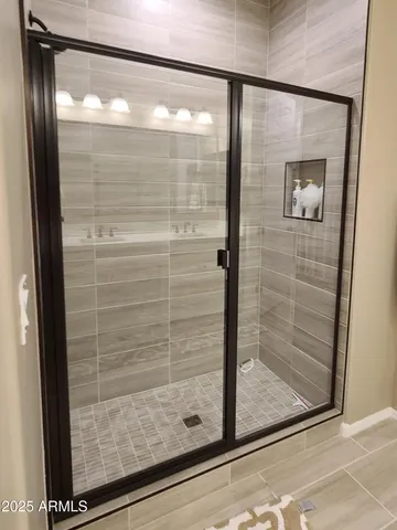 a bathroom with a glass shower door