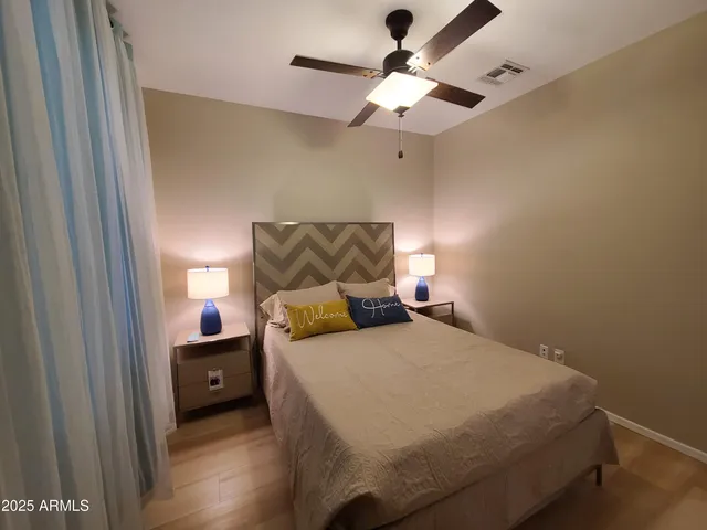 a bedroom with a bed and a chandelier