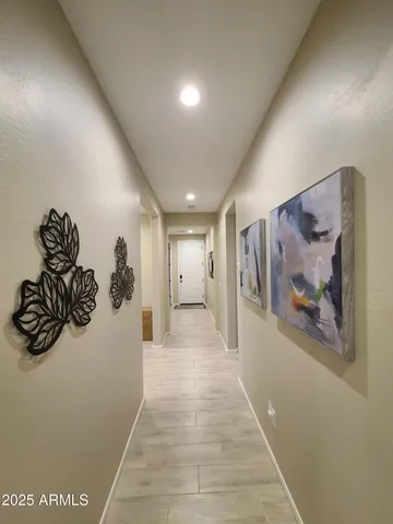 a view of a hallway with a painting on the wall