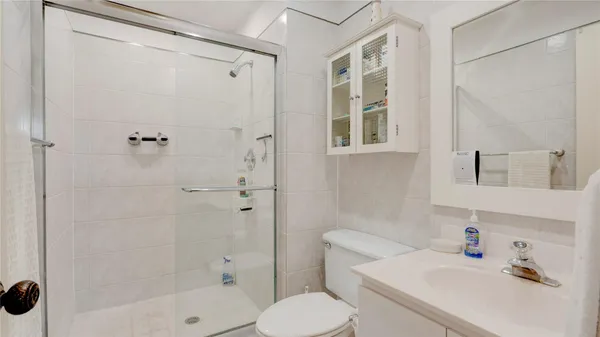 a bathroom with a sink toilet and shower