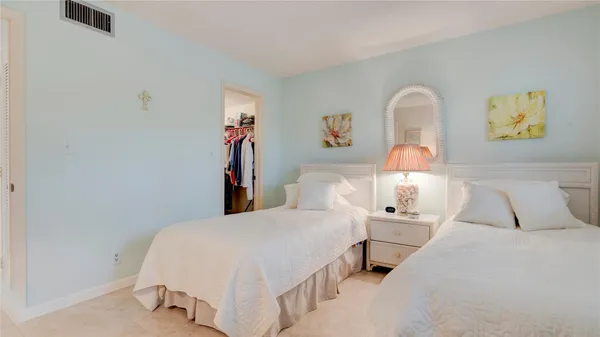 a bedroom with a bed and lamp