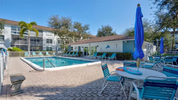 a view of a house with swimming pool and sitting area