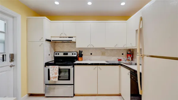 a kitchen with stainless steel appliances a sink and a refrigerator