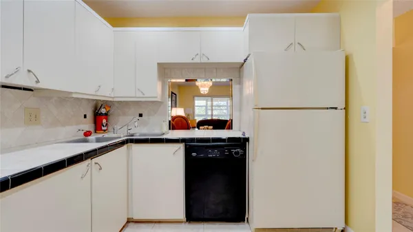 a kitchen with a sink and a refrigerator