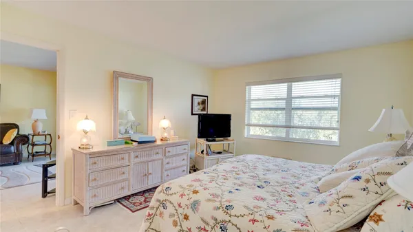 a bed room with a bed and a television