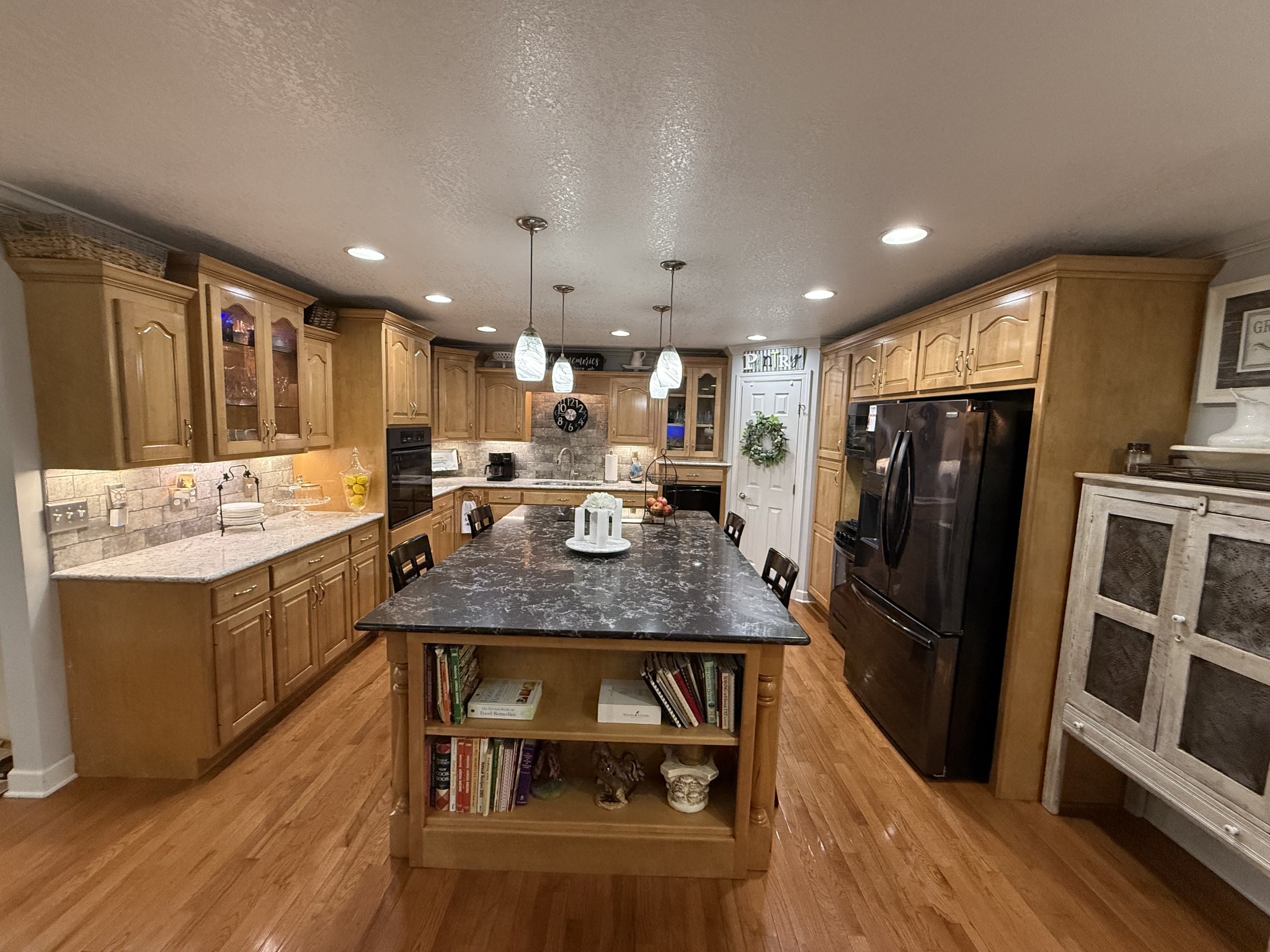 646 Indian Creek Road Huntland, TN 37345 - Photo 18 of 61 a kitchen with stainless steel appliances granite countertop a refrigerator a sink dishwasher and a stove with wooden floor