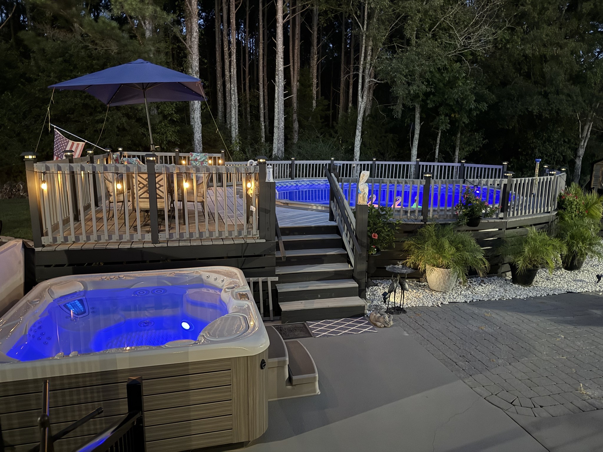 646 Indian Creek Road Huntland, TN 37345 - Photo 6 of 61 a view of a patio with table and chairs under an umbrella with wooden fence