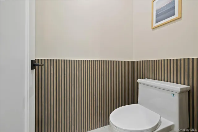 a white toilet sitting next to a small bathroom