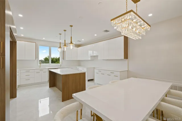 a kitchen with a table chairs and a refrigerator
