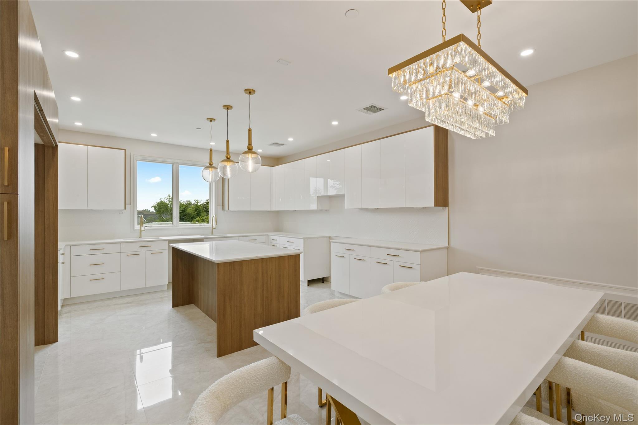 15 Ridge Avenue, Unit 204 Spring Valley, NY 10977 - Photo 12 of 41 a kitchen with a table chairs and a refrigerator
