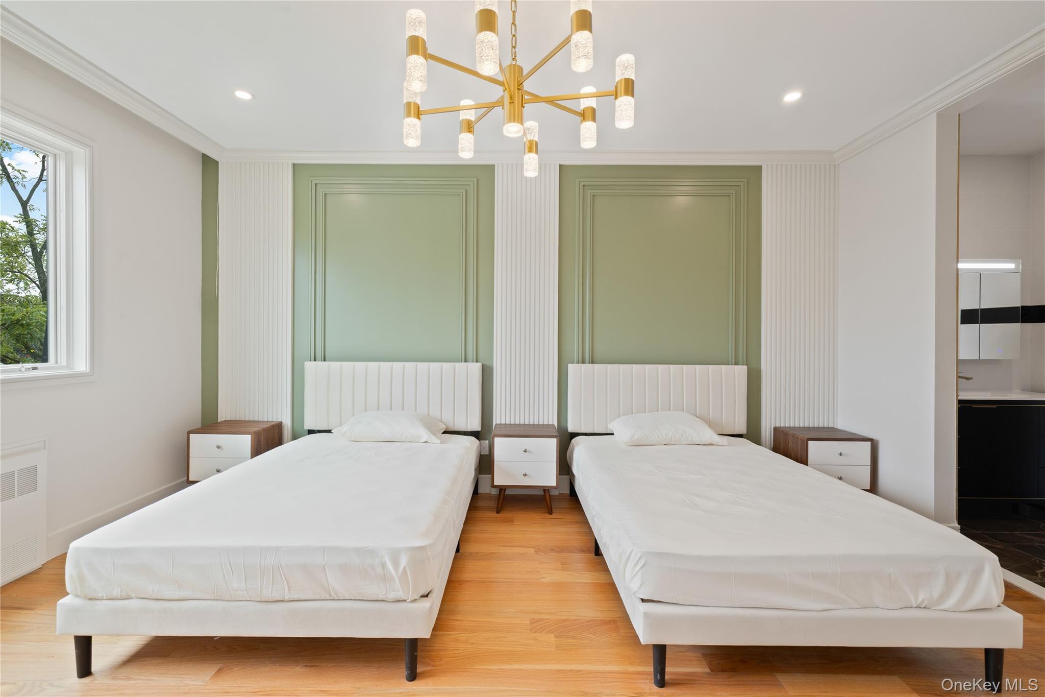 15 Ridge Avenue, Unit 204 Spring Valley, NY 10977 - Photo 18 of 41 a bedroom with double bed and a chandelier