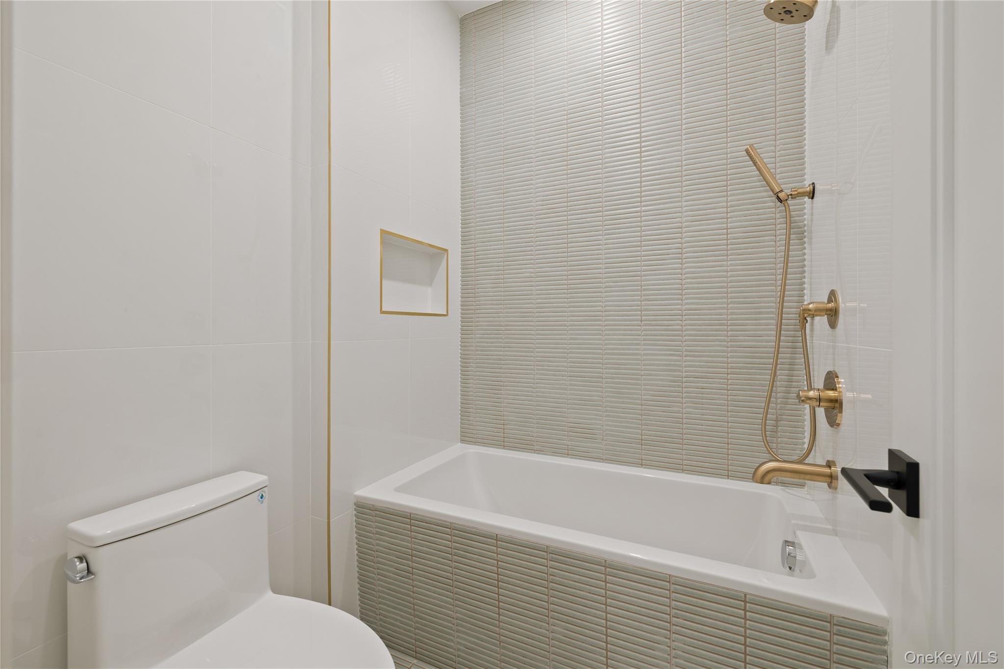 15 Ridge Avenue, Unit 204 Spring Valley, NY 10977 - Photo 25 of 41 a bathroom with a bathtub and a toilet