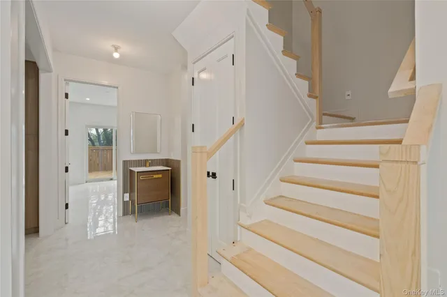 a view of entryway with white walls and stairs