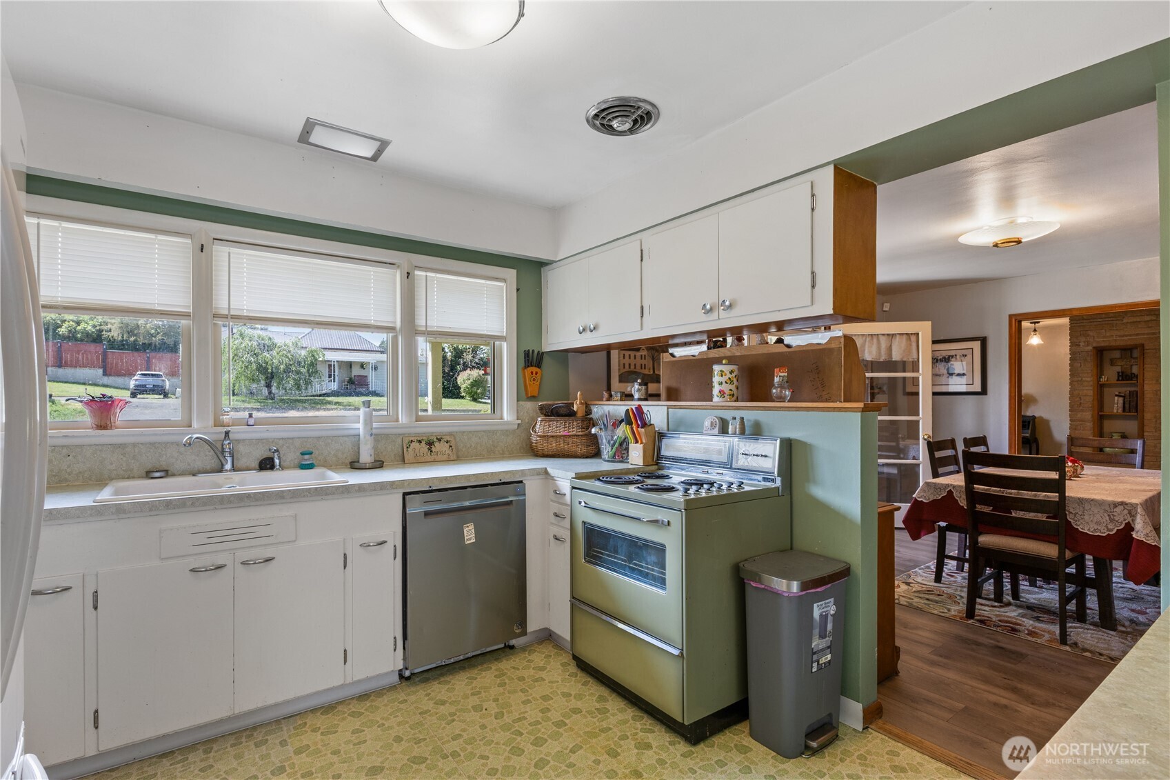 308 North 2nd Street Harrington, WA 99134 - Photo 13 of 37 a kitchen with a stove a sink and white cabinets with wooden floor