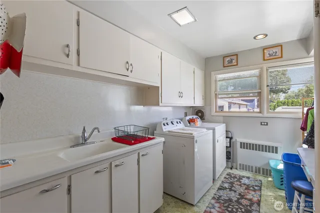 a bathroom with a double vanity sink mirror and toilet