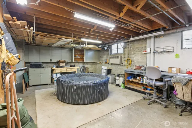 a room with fridge and a book shelf