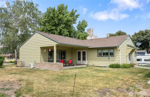 a large house with a big yard and large trees