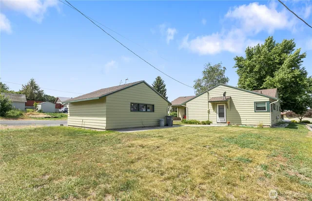a yellow house with garden in front of it