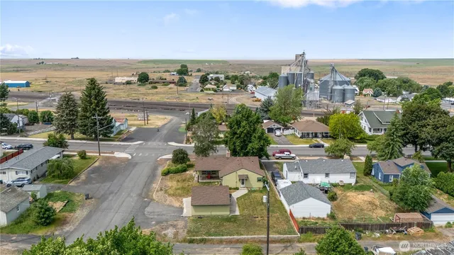 a front view of a house with a garden and parking space