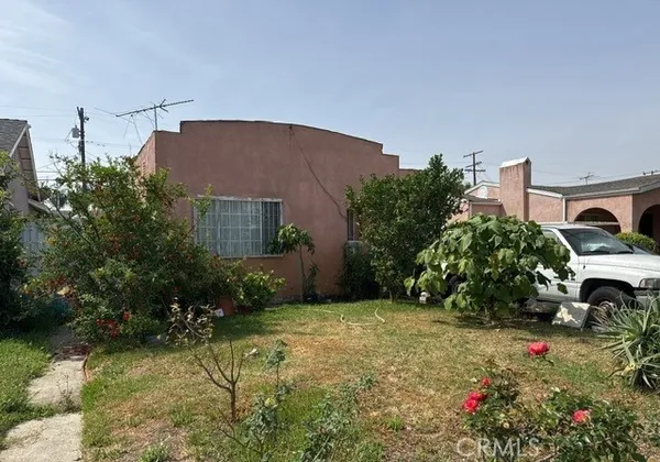a backyard of a house with lots of green space and fountain