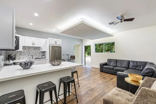 a kitchen with stainless steel appliances granite countertop a stove and a refrigerator