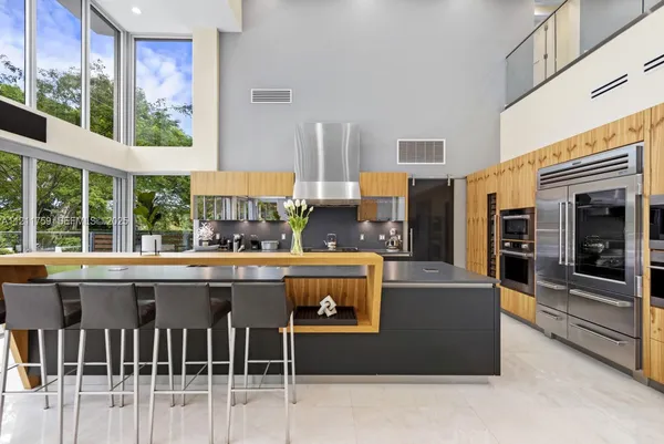 a dining room with furniture and a floor to ceiling window