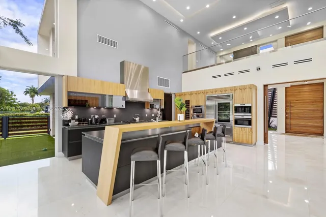 a bedroom with a bed and a flat tv screen on dresser