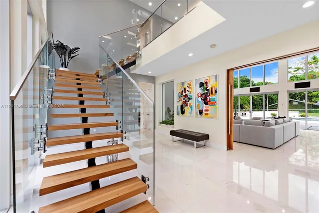 a bedroom with two beds and a chandelier