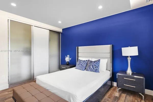 a bedroom with a bed and a large window