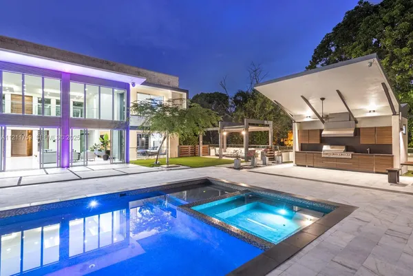 a bathroom with a sink tub double vanity and mirror