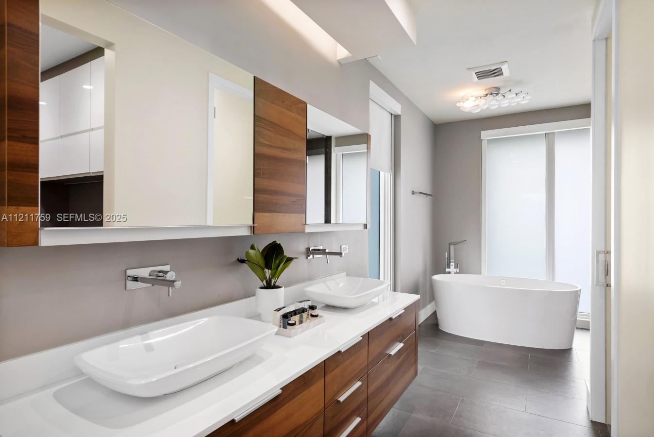 14305 Stirling Road Southwest Ranches, FL 33330 - Photo 63 of 66 a bathroom with a sink tub double vanity and mirror
