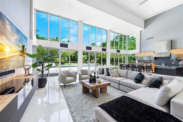 a dining room with furniture and a floor to ceiling window