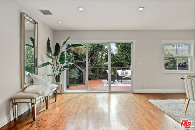 a living room with furniture and a large window with outer view