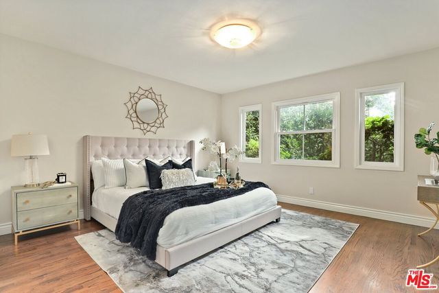 a bedroom with a large bed and a window