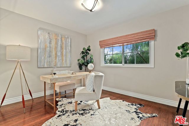 a living room with a wooden floor and a table