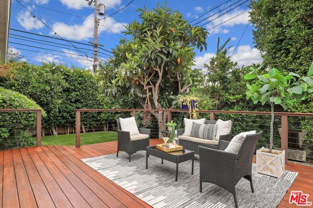 a view of a table and chairs on the roof deck