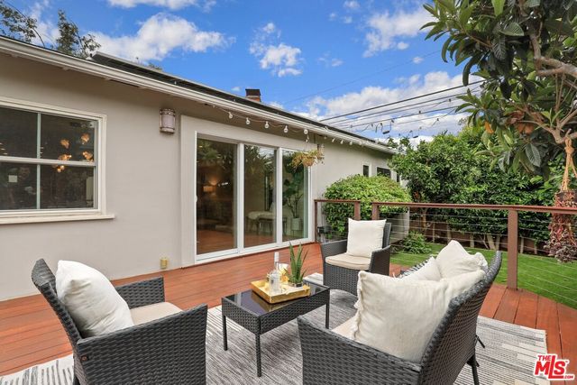 a balcony with furniture and a potted plant