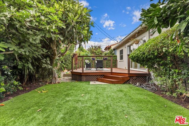 a view of house with backyard