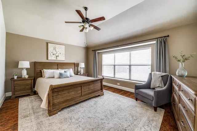 a spacious bedroom with a bed a couch and a window