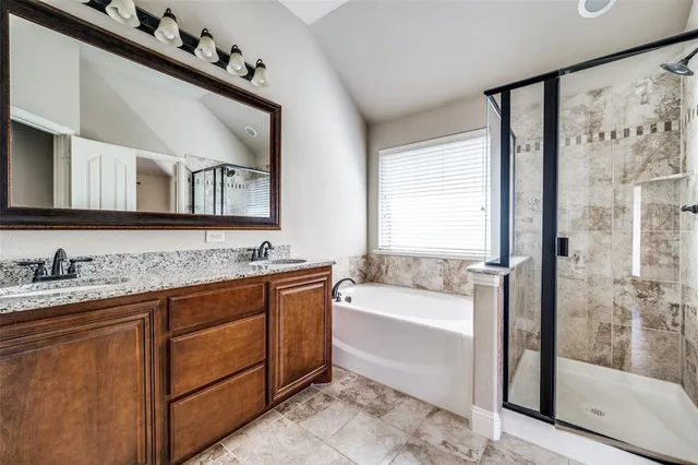 a bathroom with a tub a sink and a mirror