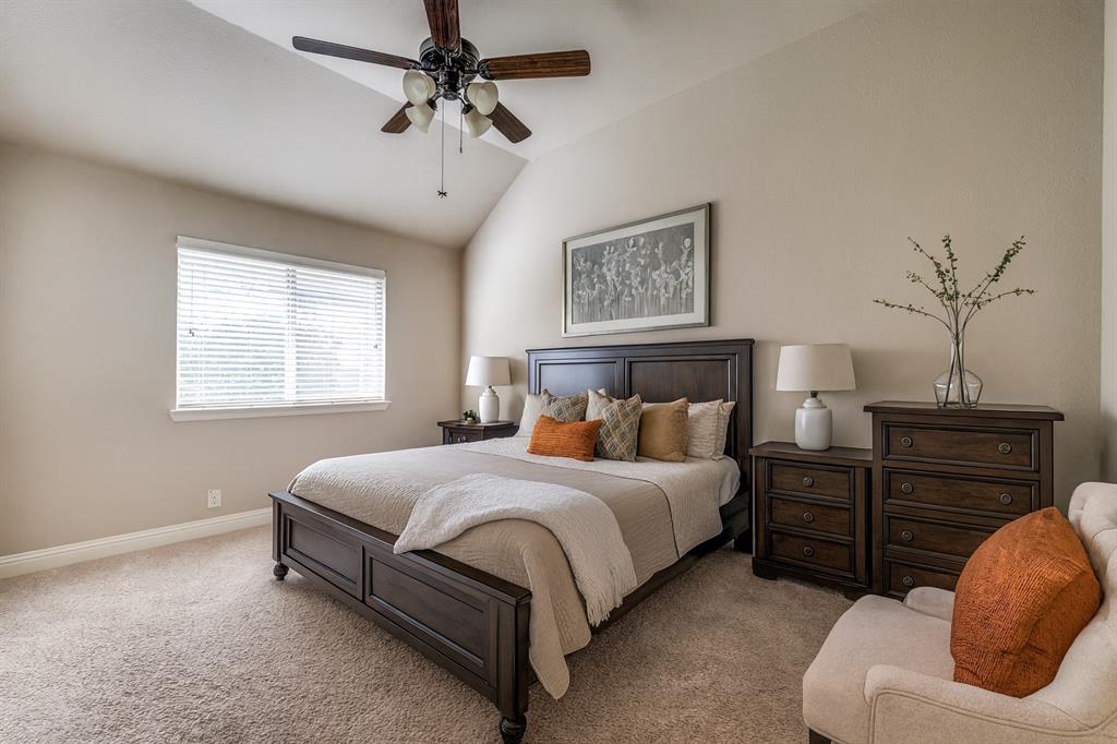 817 Lighthouse Lane Savannah, TX 76227 - Photo 18 of 20 a bedroom with a bed and wooden floor